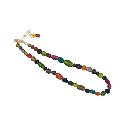A beaded necklace with multicolored oval and round beads, including green, red, orange, purple, and black, accented by gold-toned metal hardware, displayed on a white background.