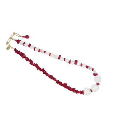 A beaded necklace featuring alternating strands of deep red textured beads and smooth white oval beads, finished with a gold-tone clasp, displayed on a light gray background.