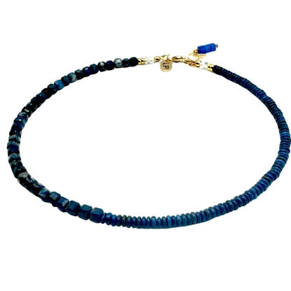 Blue beaded necklace with a gold clasp on a white background