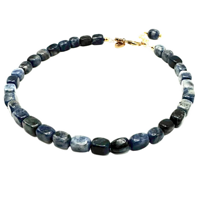 Necklace with blue and black beads on a white background