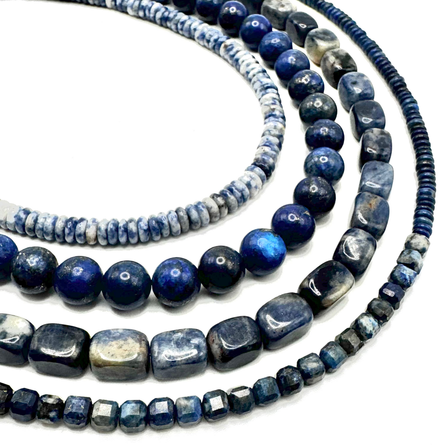 Three blue beaded necklaces on a white background