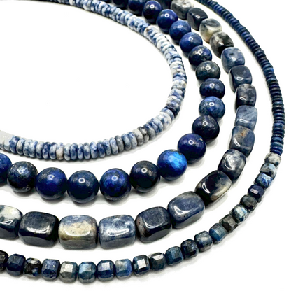 Three blue beaded necklaces on a white background