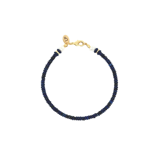 Navy beaded bracelet with a gold clasp on a white background