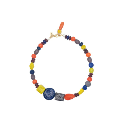 Colorful beaded necklace with a blue pendant on a white background