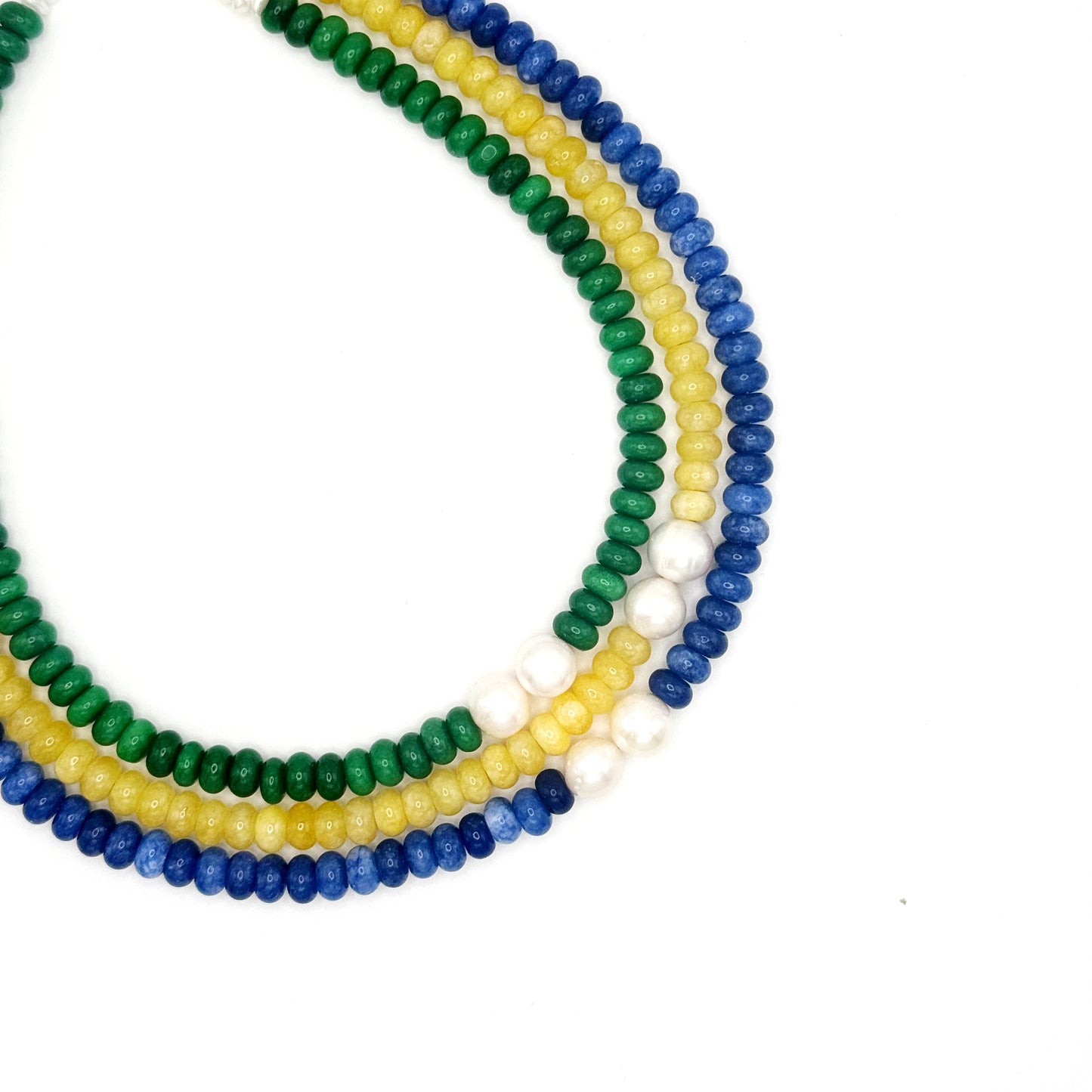 Stack of colorful beaded necklaces on a white background