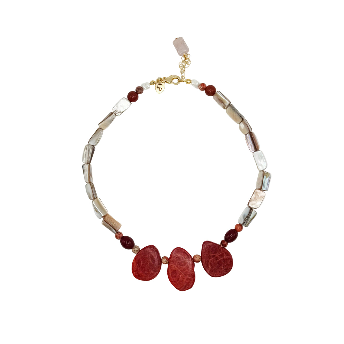 A beaded necklace featuring three large, polished red teardrop-shaped stones at the center, flanked by smaller red beads and irregular metallic silver and gold-toned beads, displayed on a clean white background.