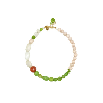 A beaded necklace featuring a mix of light pink, white, and green beads, accented by a single round red-orange bead and a small gold clasp, shown on a plain white background.