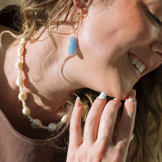 Woman wearing a necklace with a blurred background